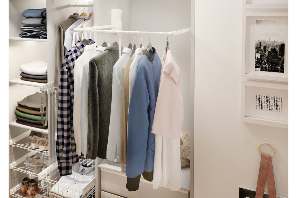 White GTV pull-down wardrobe rail lowered in a fitted wardrobe with hanging clothes
